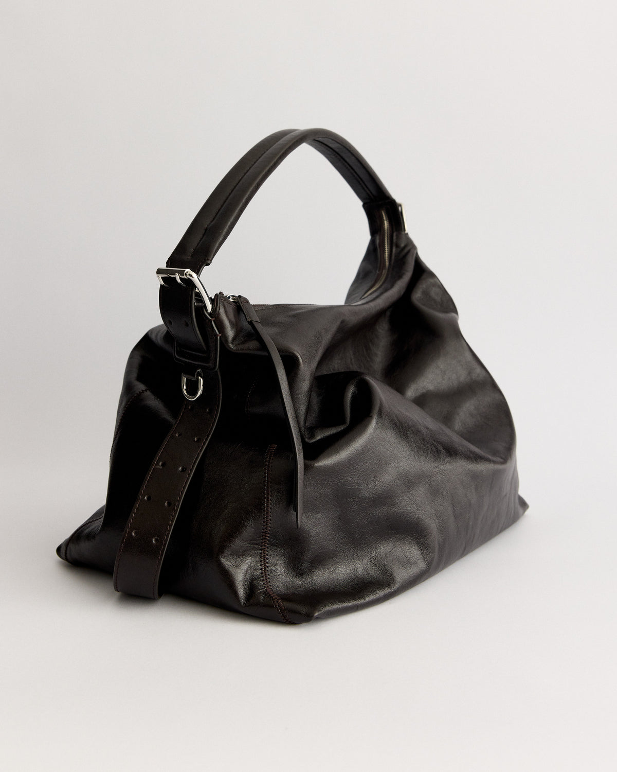 Clean silhouettes, tactile leathers, and practical details designed to ground your daily uniform.