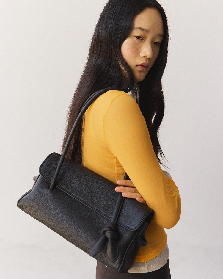 Clean silhouettes, tactile leathers, and practical details designed to ground your daily uniform.