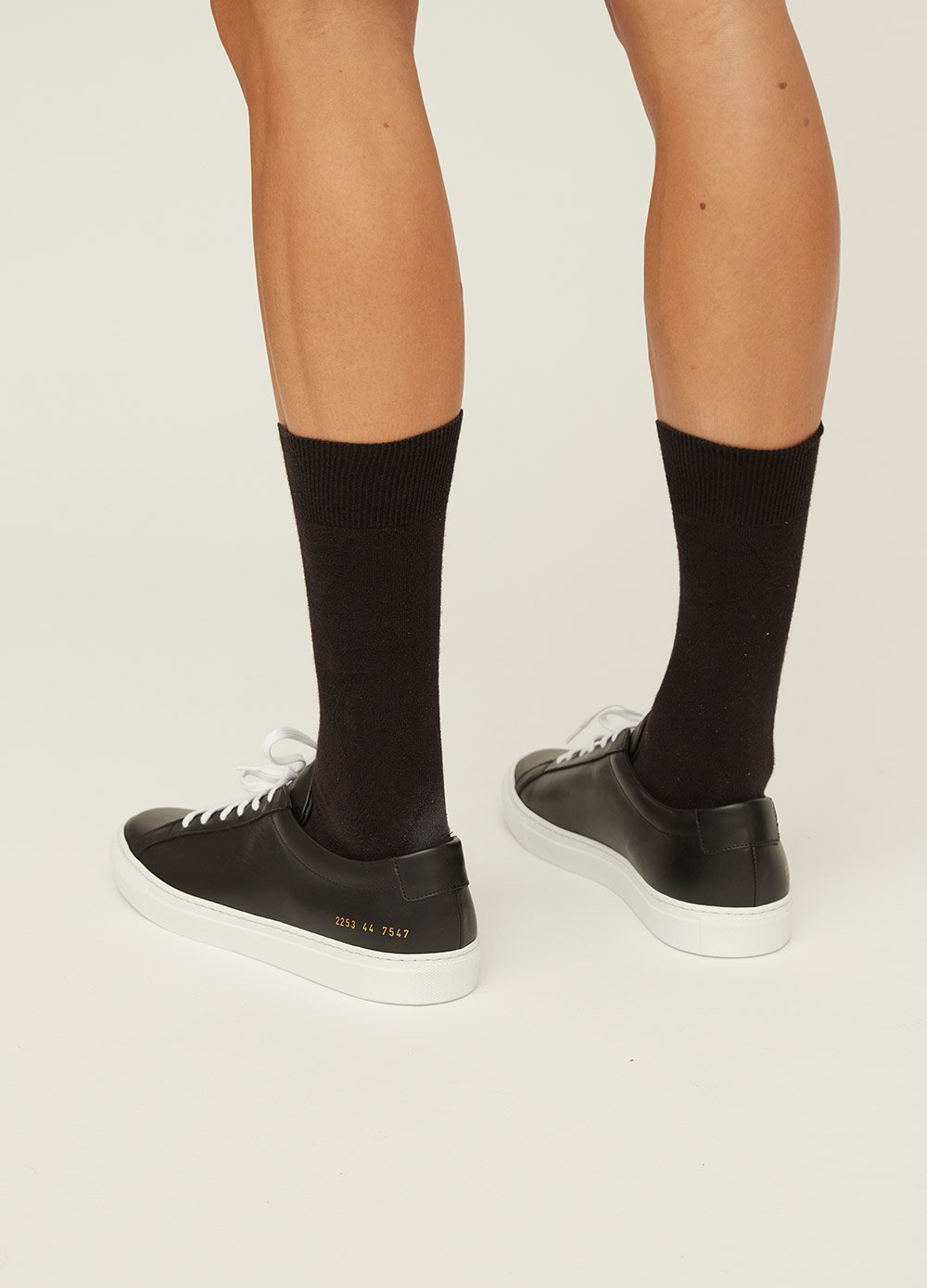 Common projects black on feet top